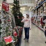 Nolan from the PeakPlus team evaluating Christmas trees at a charity event.